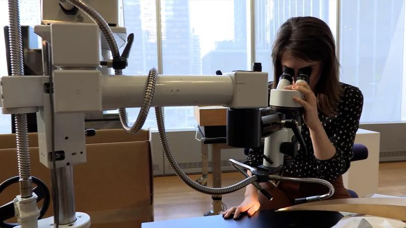 recent alum looking through microscope